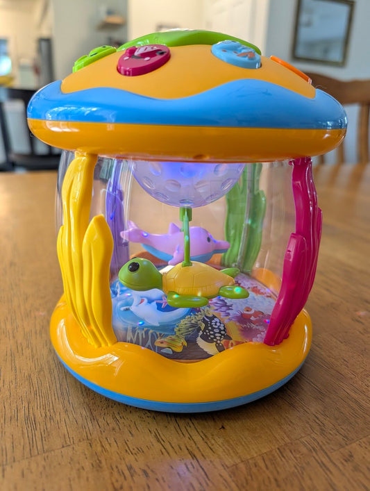 Musical light-up toy, internalrotating sea animals Ocean theme, buttons change colors and sounds Infant