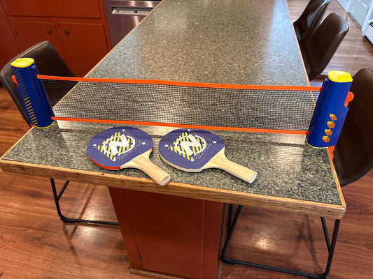 Nerf retractable table top next and paddles Opens to 5.5 feet, one paddle has a red mark Games