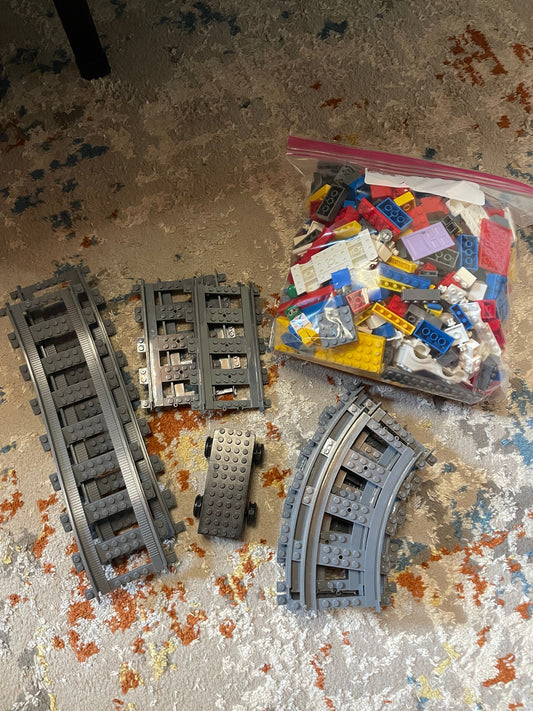 Lego Train track and battery base for train with assortment of LEGOs Building
