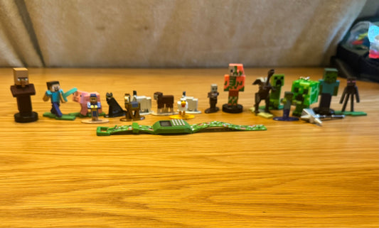 Minecraft Misc metal and plastic figurines, a watc Misc metal and plastic figurines, a watch, and a keychain Figures and Animals