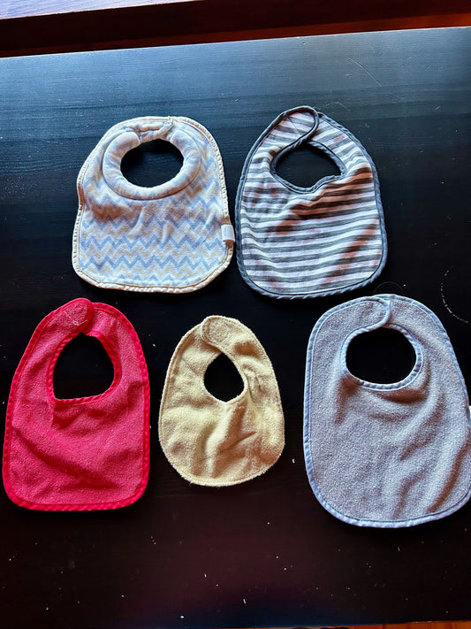 Baby Essentials and Tommee Tippee Baby Bib Bundle Set of 5 baby bibs in assorted colors and patterns.