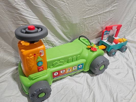 Fisher Price green ride on tractor Laugh & Learn 4-in-1 Farm to Market Tractor Ride-On Toy