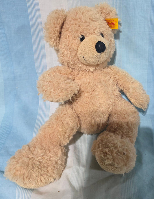 Steiff Fynn Teddy Bear beige, cuddly soft plush fur and features plastic button eyes. Plush Toys
